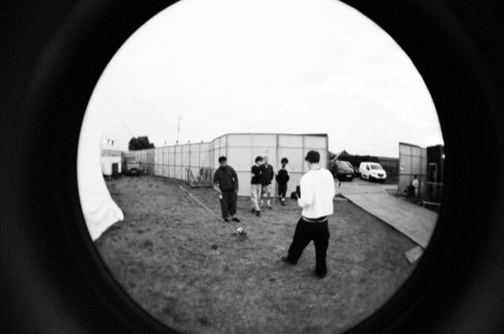 Fisheye view of friends walking across the site
