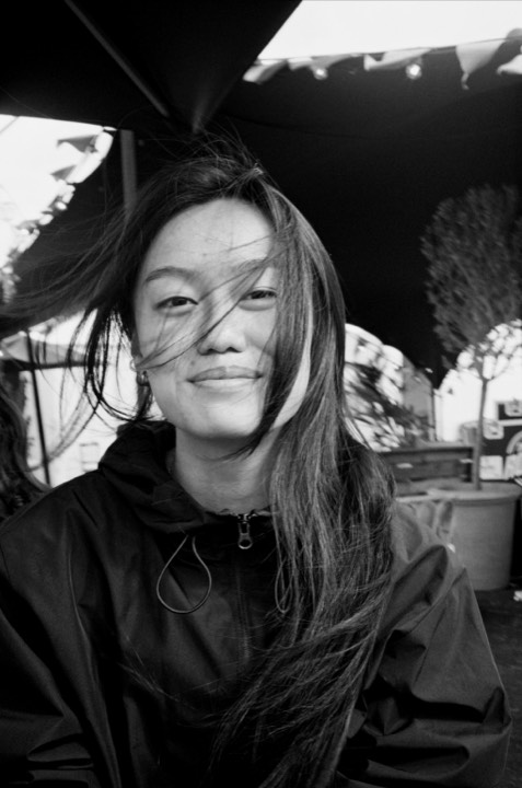 A woman smiling, in black and white